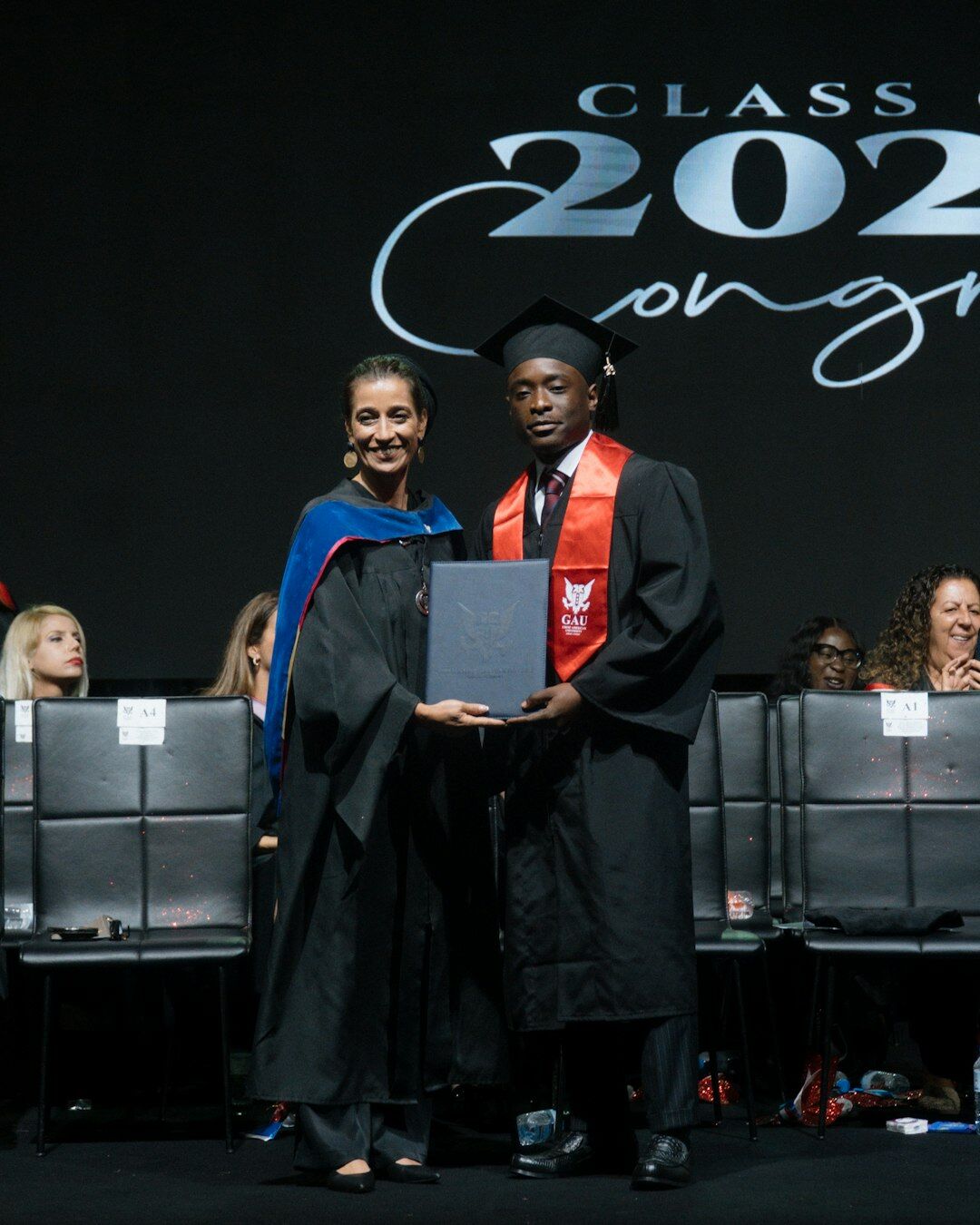 Graduate receiving a certificate at a ceremony
