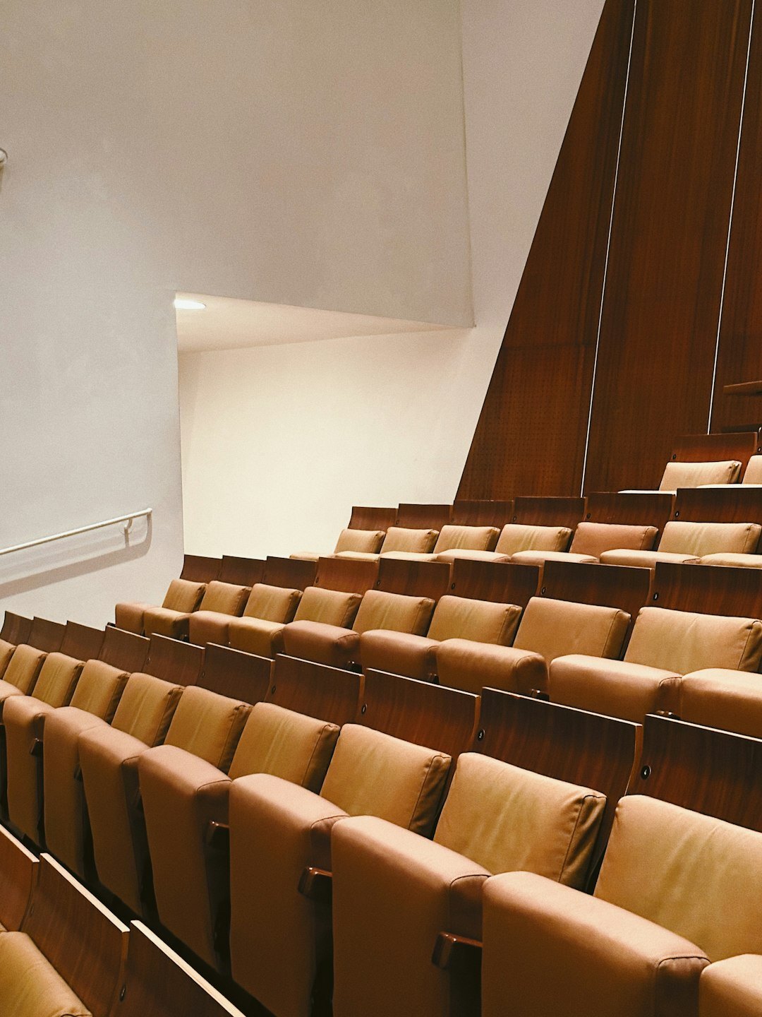 Elegant lecture hall with wooden seats and podium